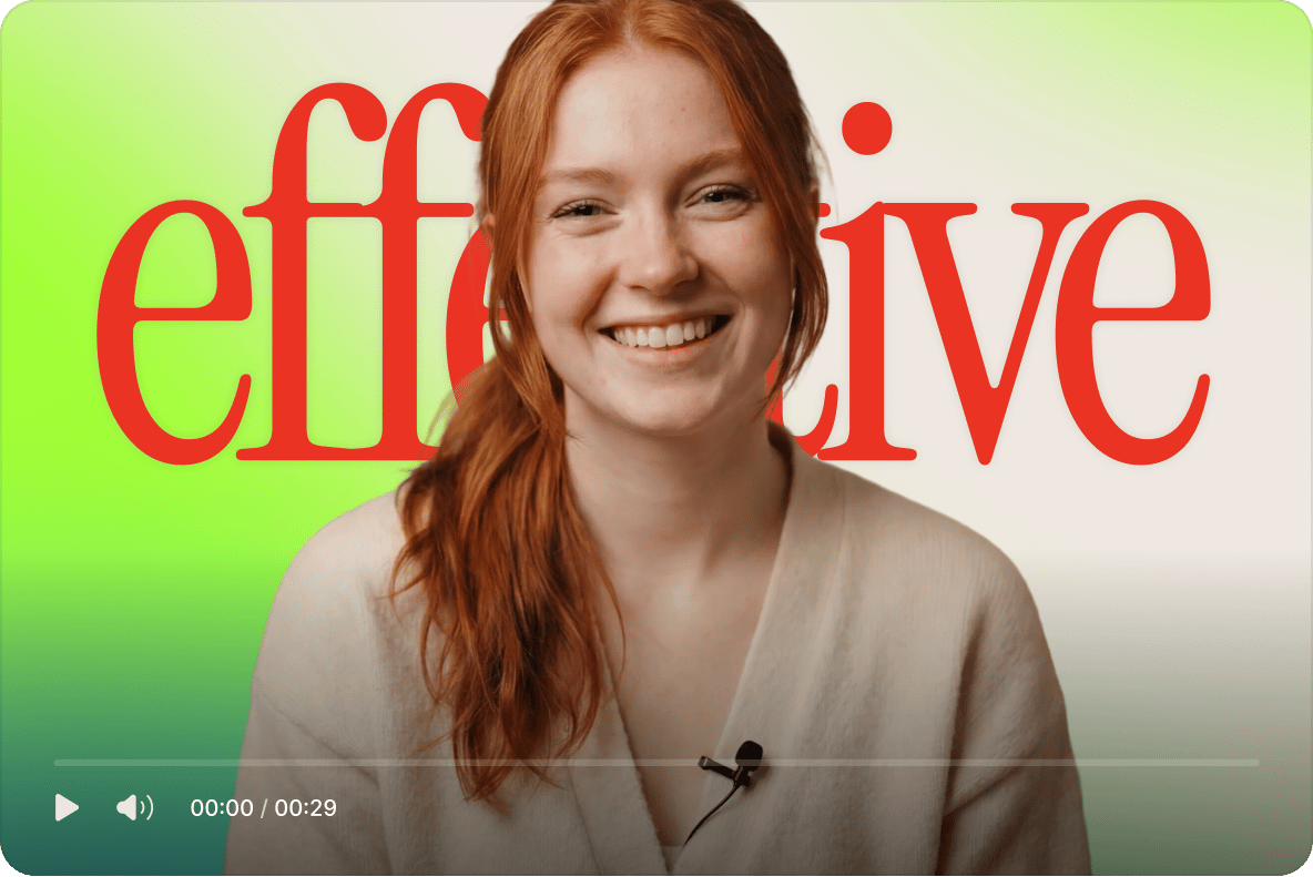Smiling redhead woman hosting a training video with the word effective displayed behind her on a green gradient background.