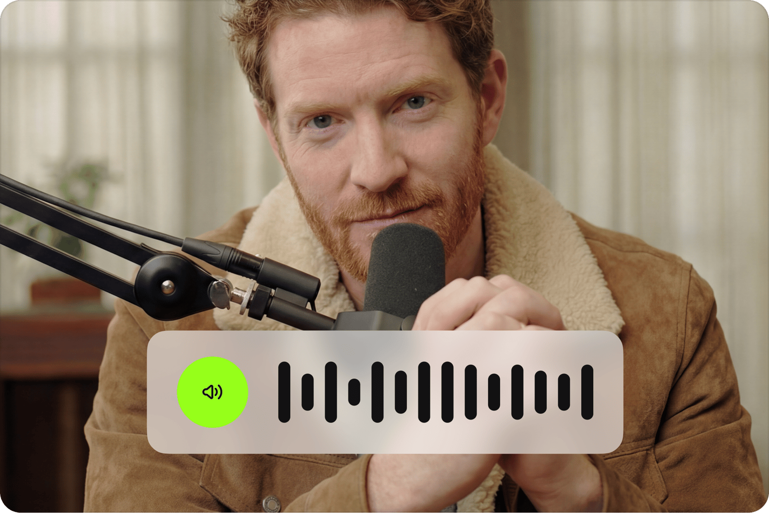 Audio waveform overlay on a professional looking video preview of a redhead man speaking into a podcast microphone