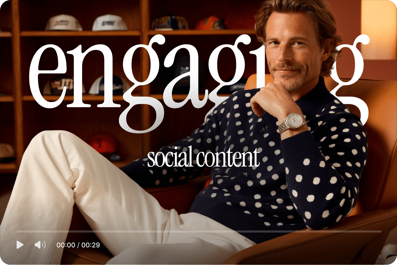 Video player showing engaging social content subtitles over a smiling man in a polka dot sweater sitting in a chair