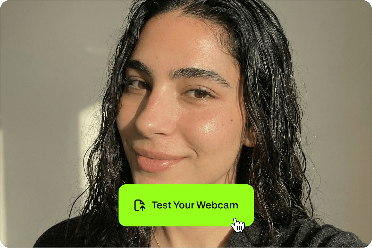 Test your webcam showing cursor clicking the green test your webcam button over a video feed of a smiling woman