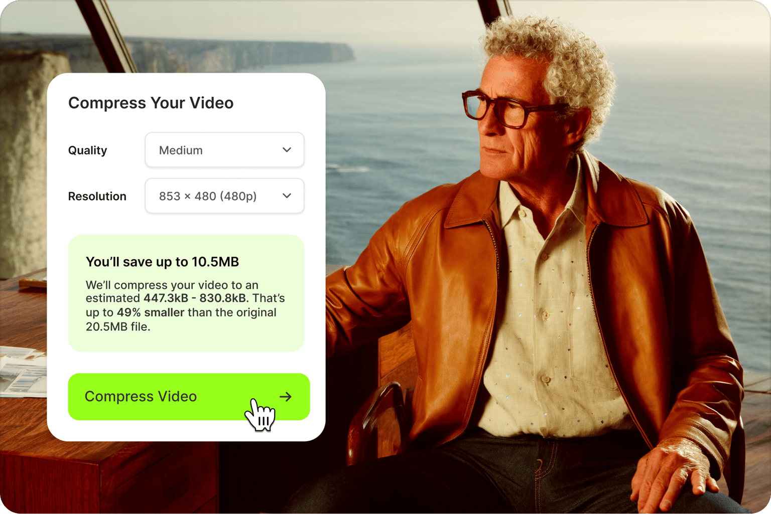 Video compressor tool showing cursor clicking compress video button over a video of a man in a brown jacket by the ocean