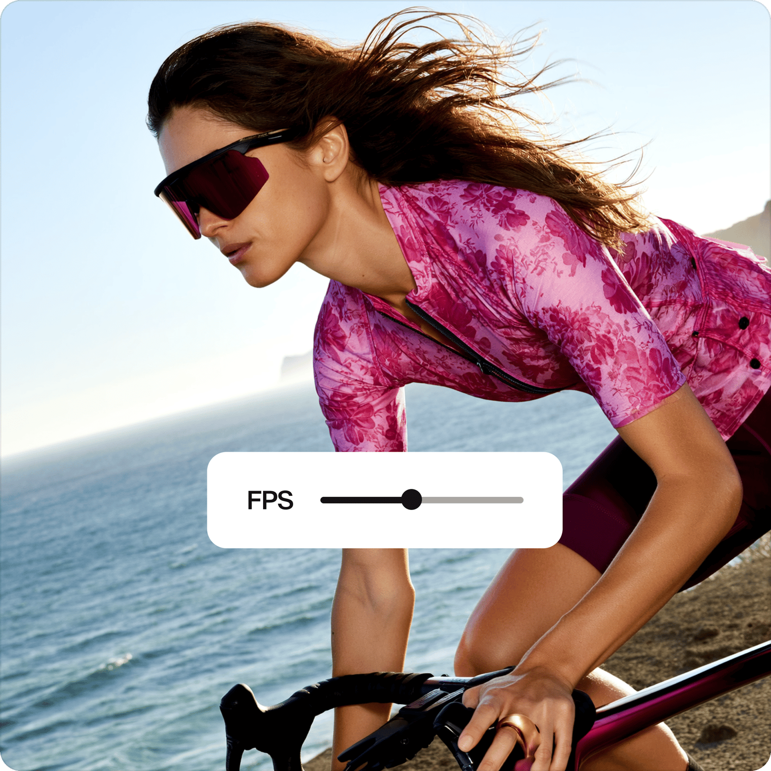 Video frame rate converter showing an FPS slider over a video of a woman in sunglasses cycling near the ocean