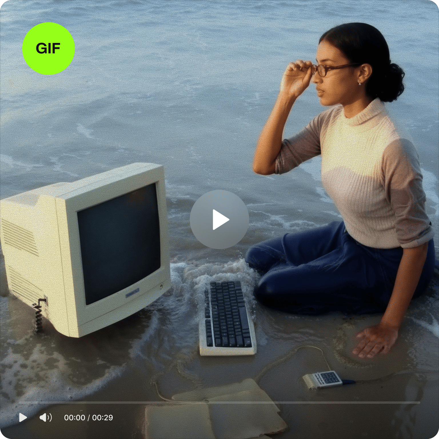 Video to photo tool showing a GIF icon over a video of a woman sitting in the ocean with an old computer