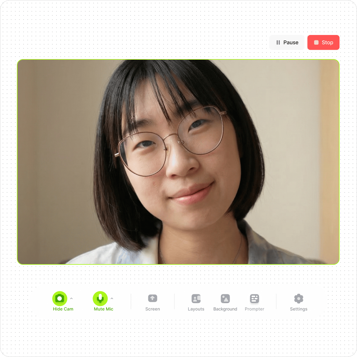 Woman with glasses looking into a webcam recorder interface showing pause and stop recording buttons.