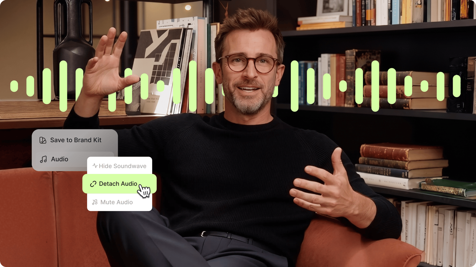 Man in glasses talking in front of a bookshelf with a soundwave overlay and a cursor clicking detach audio.