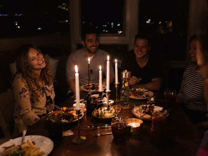 Unblurred photo of friends at a candlelit dinner