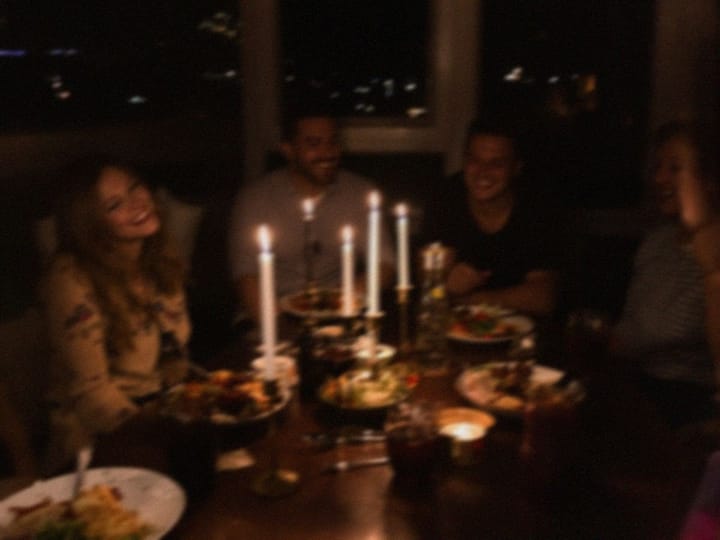 Blurry photo of friends at a candlelit dinner