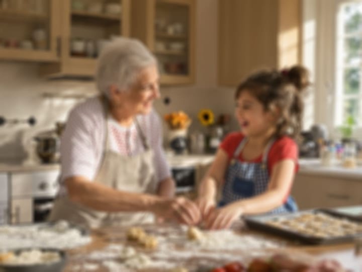 Blurry photo of a grandmother and granddaughter baking together