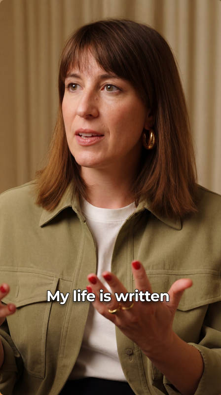 A presenter in a tan jacket telling a story to the camera
