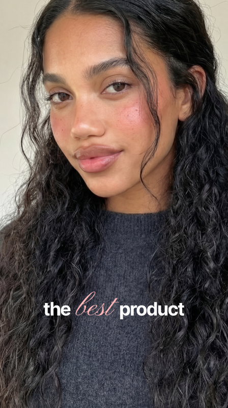 A presenter with long curly hair reviewing a product to camera
